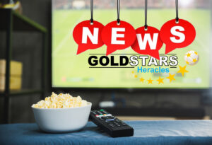 Popcorn and television remote control on football program tv scr